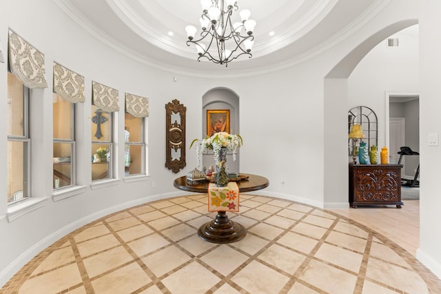 9436 Hufsmith Rd, Tomball, TX 77375 - hallway with arched walkways, inlaid floor details, a chandelier, crown molding, and a tray ceiling