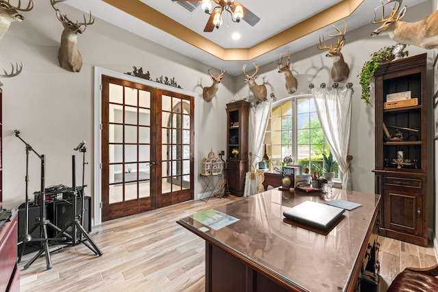 9436 Hufsmith Rd, Tomball, TX 77375 - office featuring french doors, light wood-style flooring, a ceiling fan, and a tray ceiling