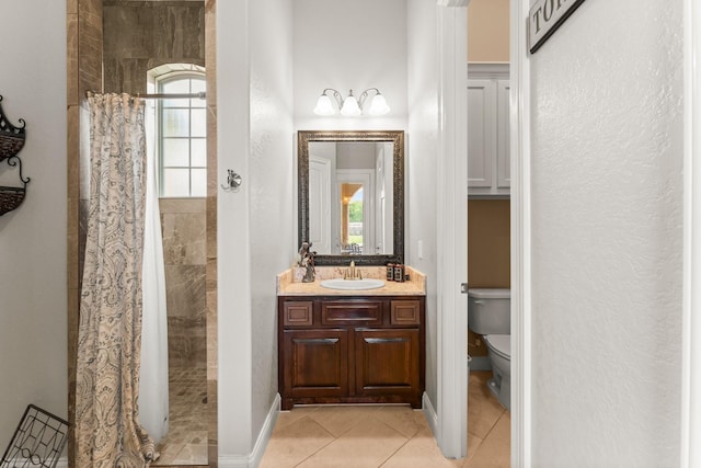 9436 Hufsmith Rd, Tomball, TX 77375 - full bath with toilet, a tile shower, tile patterned flooring, vanity, and baseboards