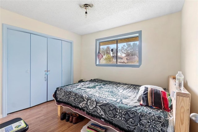 1927 Dormstom Ln, Houston, TX 77088 - bedroom with wood finished floors, a closet, and a textured ceiling