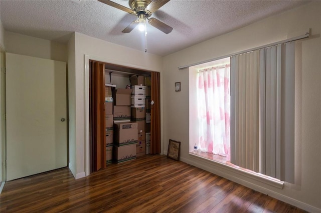 1927 Dormstom Ln, Houston, TX 77088 - empty room with dark wood-type flooring, a textured ceiling, ceiling fan, and baseboards