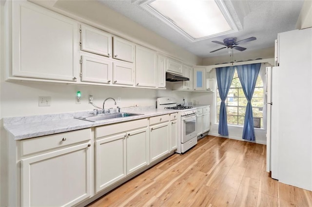 1927 Dormstom Ln, Houston, TX 77088 - kitchen featuring gas range gas stove, a sink, white cabinets, under cabinet range hood, and a ceiling fan