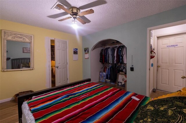 1927 Dormstom Ln, Houston, TX 77088 - bedroom featuring a closet, a textured ceiling, ceiling fan, baseboards, and wood finished floors
