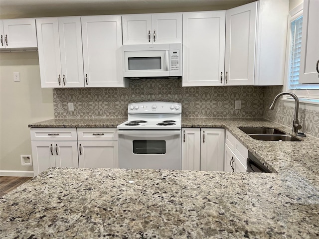 1705 Westwind Dr, Brenham, TX 77833 - kitchen with white appliances, a sink, and white cabinets