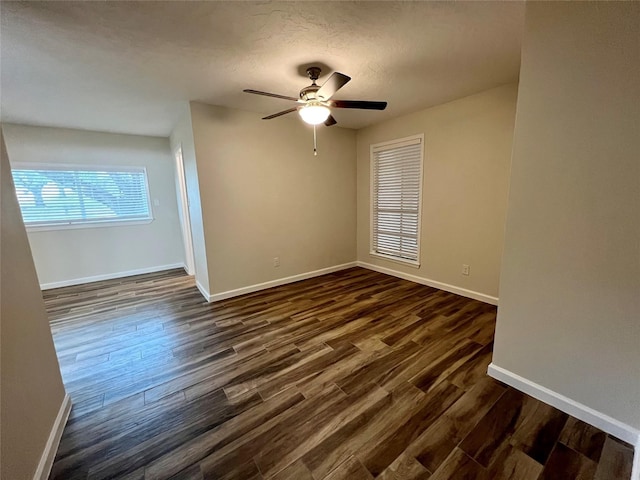 1705 Westwind Dr, Brenham, TX 77833 - spare room with baseboards, dark wood-type flooring, and a textured ceiling