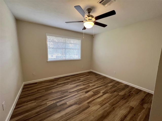 1705 Westwind Dr, Brenham, TX 77833 - unfurnished room with dark wood-style floors, ceiling fan, and baseboards