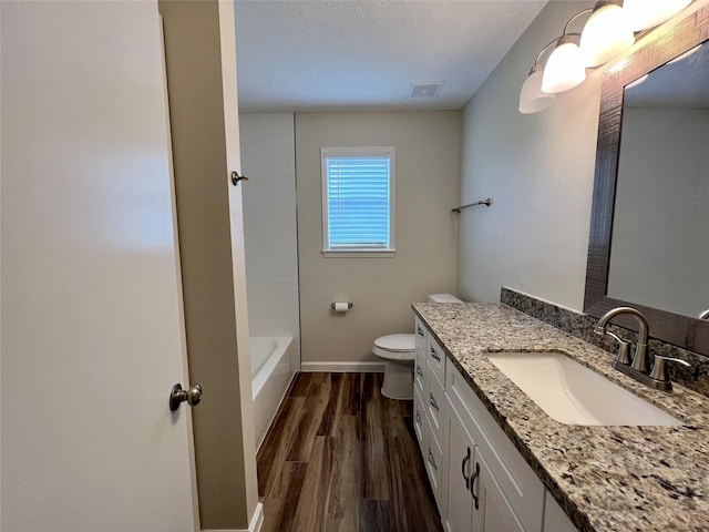1705 Westwind Dr, Brenham, TX 77833 - bathroom with toilet, wood finished floors, vanity, and baseboards