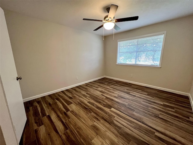1705 Westwind Dr, Brenham, TX 77833 - spare room featuring dark wood-style floors, baseboards, and ceiling fan