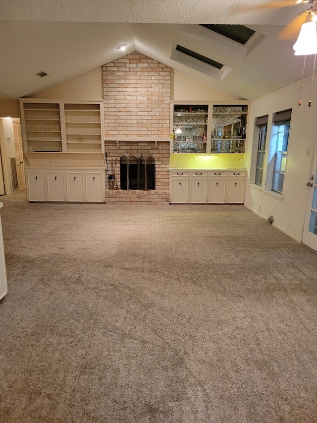 209 Montclaire Dr, West Columbia, TX 77486 - unfurnished living room with lofted ceiling, carpet flooring, a fireplace, a ceiling fan, and a textured ceiling