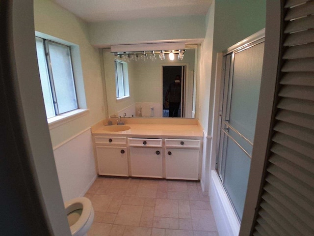 209 Montclaire Dr, West Columbia, TX 77486 - bathroom featuring vanity, a shower with shower door, and stone finish flooring