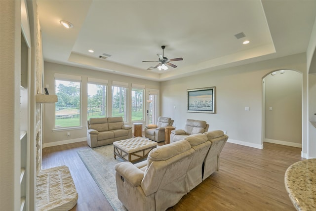 13606 Oak Harbor Bnd, Cypress, TX 77429 - living room with a tray ceiling, ceiling fan, light wood-style flooring, and recessed lighting