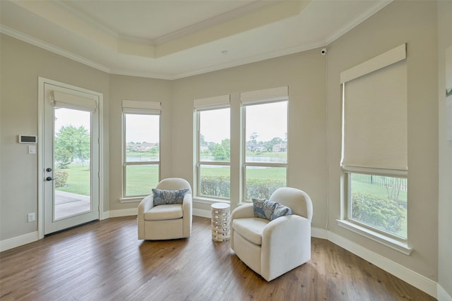 13606 Oak Harbor Bnd, Cypress, TX 77429 - living area featuring a raised ceiling, wood finished floors, ornamental molding, and baseboards