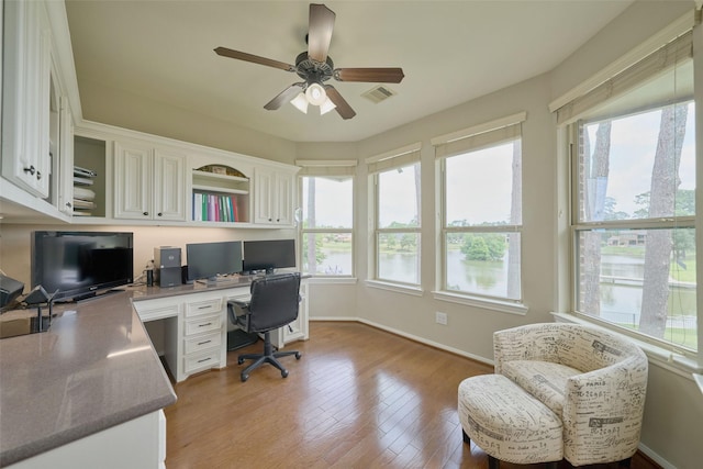 13606 Oak Harbor Bnd, Cypress, TX 77429 - office area with healthy amount of natural light, built in desk, ceiling fan, and baseboards