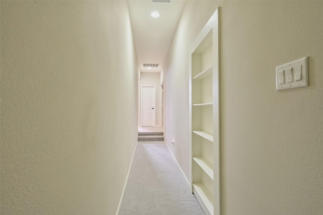 13606 Oak Harbor Bnd, Cypress, TX 77429 - hallway featuring carpet flooring, built in features, baseboards, and a textured wall