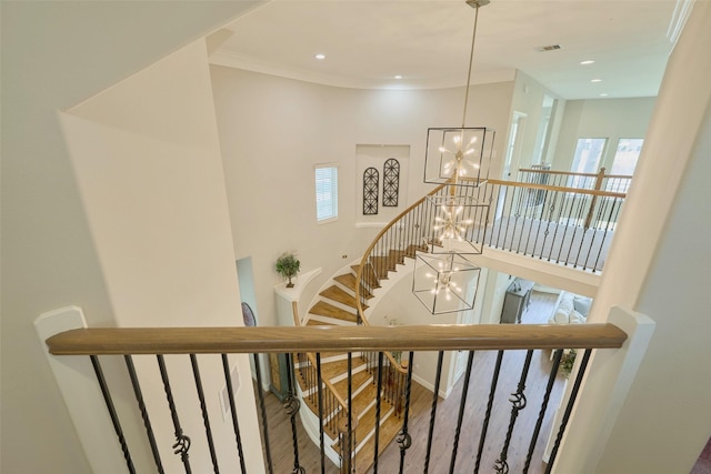 13606 Oak Harbor Bnd, Cypress, TX 77429 - staircase featuring a chandelier, plenty of natural light, ornamental molding, wood finished floors, and a high ceiling