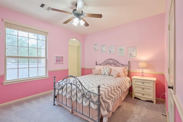 13606 Oak Harbor Bnd, Cypress, TX 77429 - carpeted bedroom with arched walkways, baseboards, and ceiling fan