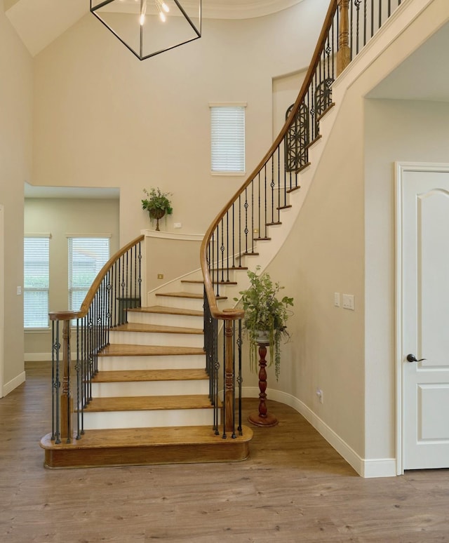 13606 Oak Harbor Bnd, Cypress, TX 77429 - staircase featuring a high ceiling, wood finished floors, and baseboards