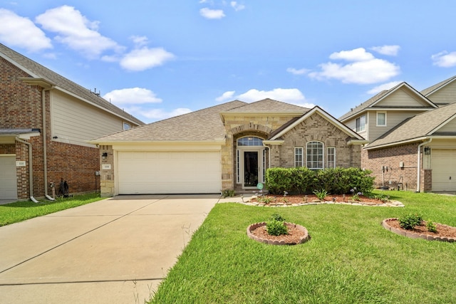 view of front of house with an attached garage, driveway, a front yard, brick siding, and a shingled roof