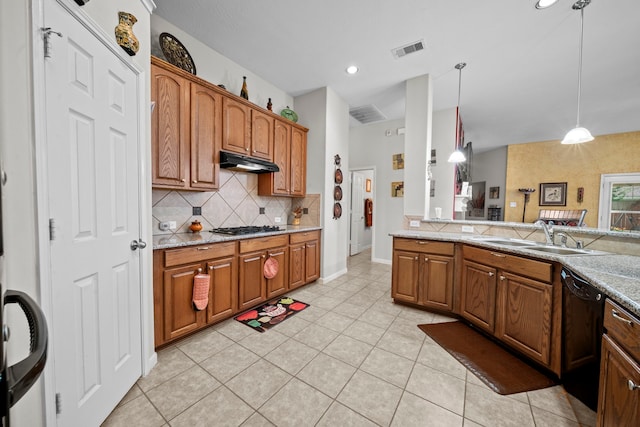 kitchen featuring dishwasher, under cabinet range hood, tasteful backsplash, a sink, and light tile patterned floors