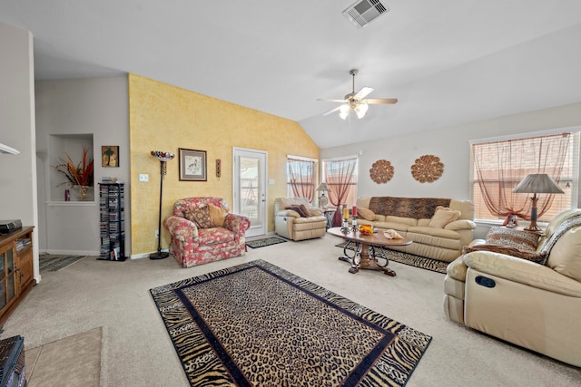 carpeted living area featuring ceiling fan, vaulted ceiling, and baseboards