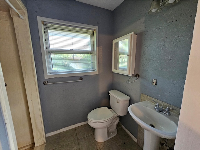111 Carnation St, Lake Jackson, TX 77566 - bathroom with a sink, toilet, tile patterned flooring, and baseboards