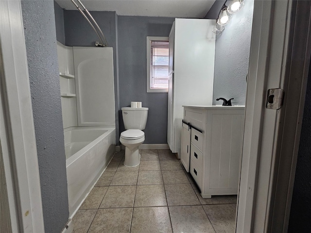 111 Carnation St, Lake Jackson, TX 77566 - bathroom featuring tile patterned floors, toilet, vanity, tub / shower combination, and a textured wall