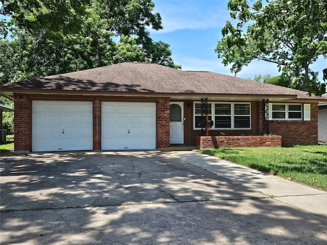 111 Carnation St, Lake Jackson, TX 77566 - view of front of home featuring a garage, driveway, brick siding, and roof with shingles