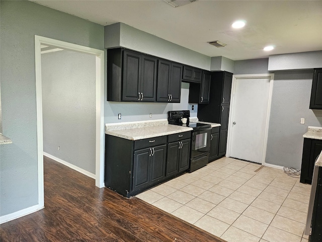 111 Carnation St, Lake Jackson, TX 77566 - kitchen featuring black electric range oven, dark cabinets, light countertops, baseboards, and recessed lighting