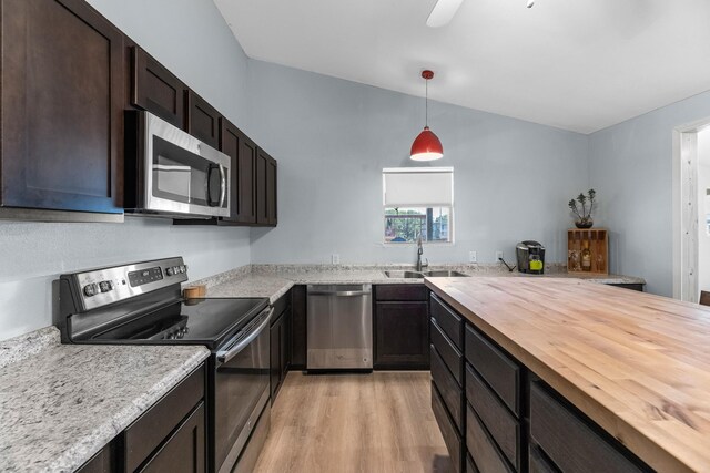 518 Marine Way, Freeport, TX 77541 - kitchen with stainless steel appliances, butcher block counters, a sink, light wood-style flooring, and dark brown cabinets