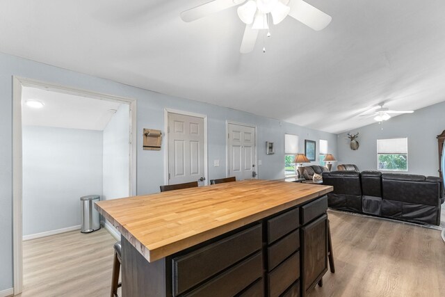 518 Marine Way, Freeport, TX 77541 - kitchen featuring butcher block countertops, ceiling fan, light wood-type flooring, a kitchen breakfast bar, and a center island