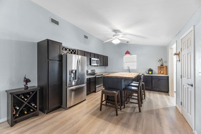 518 Marine Way, Freeport, TX 77541 - kitchen with appliances with stainless steel finishes, lofted ceiling, light wood-style floors, wood counters, and a ceiling fan