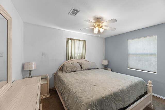 518 Marine Way, Freeport, TX 77541 - bedroom featuring dark carpet, baseboards, and a ceiling fan