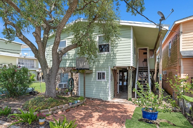 518 Marine Way, Freeport, TX 77541 - view of front of home featuring stairway, fence, and cooling unit