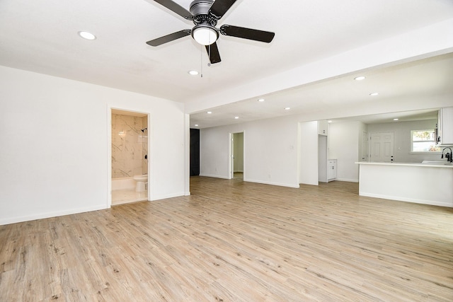 1915 Springrock Ln, Houston, TX 77080 - unfurnished living room featuring a sink, recessed lighting, light wood-style floors, a ceiling fan, and baseboards