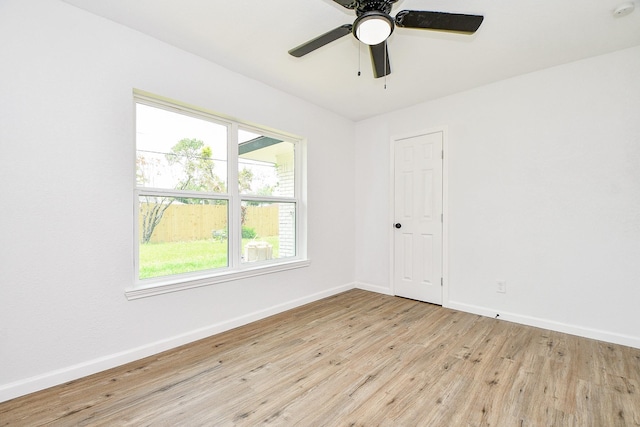 1915 Springrock Ln, Houston, TX 77080 - empty room with light wood-type flooring, healthy amount of natural light, baseboards, and a ceiling fan