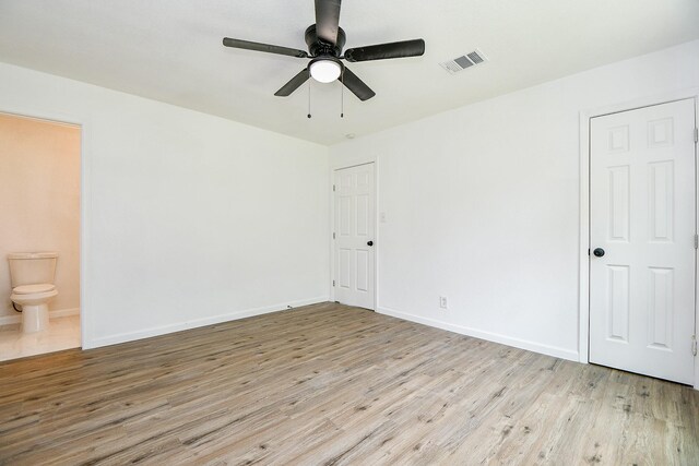 1915 Springrock Ln, Houston, TX 77080 - unfurnished bedroom with wood finished floors, baseboards, ensuite bath, and a ceiling fan