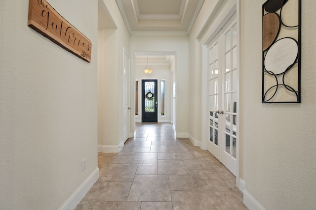 doorway to outside with french doors, ornamental molding, and baseboards
