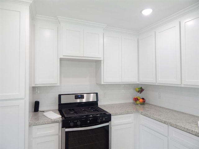 846 Magnolia St, Lake Jackson, TX 77566 - kitchen with gas range, white cabinets, decorative backsplash, and light stone countertops