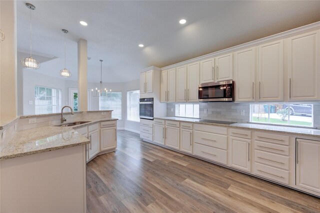 12507 Antean Way Ct, Houston, TX 77065 - kitchen featuring a sink, oven, stainless steel microwave, a chandelier, and black electric stovetop