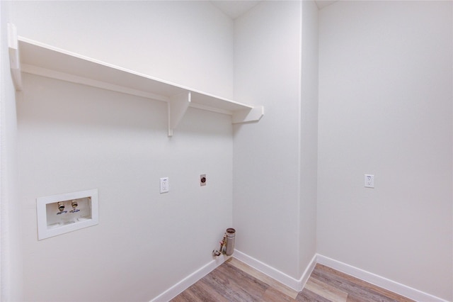 12507 Antean Way Ct, Houston, TX 77065 - laundry area featuring washer hookup, hookup for an electric dryer, light wood finished floors, gas dryer hookup, and baseboards