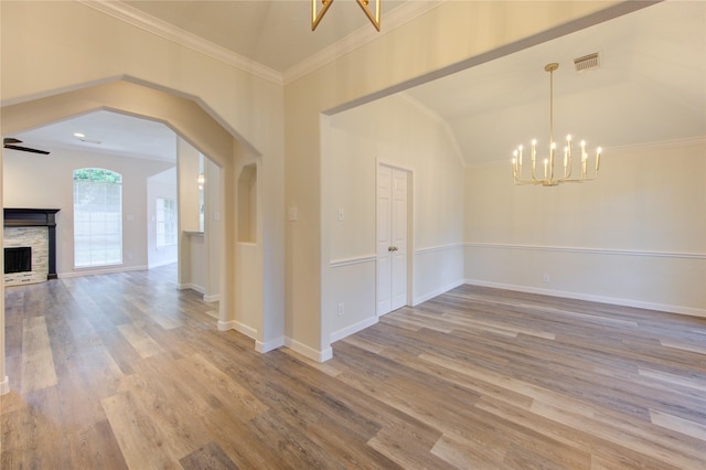 12507 Antean Way Ct, Houston, TX 77065 - unfurnished dining area featuring a chandelier, wood finished floors, a stone fireplace, crown molding, and baseboards