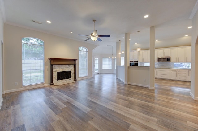 12507 Antean Way Ct, Houston, TX 77065 - unfurnished living room featuring healthy amount of natural light, a fireplace, light wood-style flooring, recessed lighting, and a ceiling fan