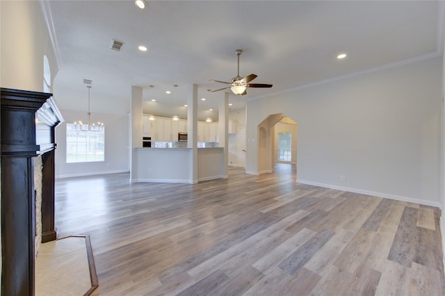 12507 Antean Way Ct, Houston, TX 77065 - unfurnished living room featuring arched walkways, crown molding, ceiling fan, a fireplace, and baseboards