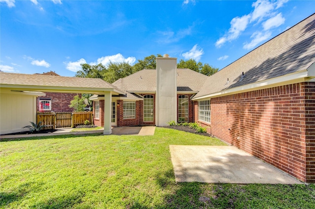 12507 Antean Way Ct, Houston, TX 77065 - back of property featuring brick siding, a patio area, and a chimney
