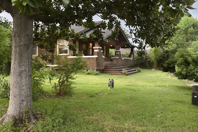 605 Sue St, Houston, TX 77009 - view of green lawn with a porch