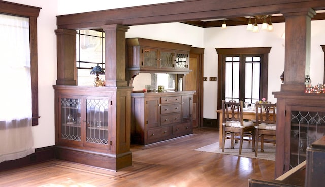 605 Sue St, Houston, TX 77009 - bar featuring wood finished floors, decorative columns, and healthy amount of natural light