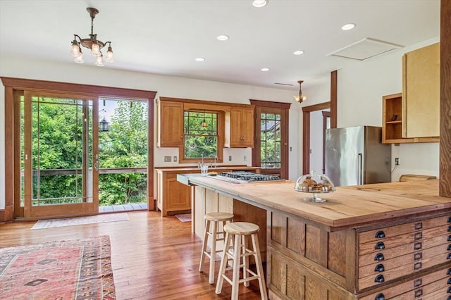 605 Sue St, Houston, TX 77009 - kitchen featuring stainless steel appliances, plenty of natural light, wooden counters, a kitchen breakfast bar, and recessed lighting