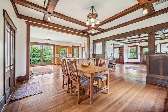 605 Sue St, Houston, TX 77009 - dining room featuring a chandelier, coffered ceiling, beam ceiling, light wood finished floors, and baseboards