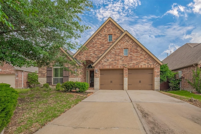 view of front of home with brick siding and driveway