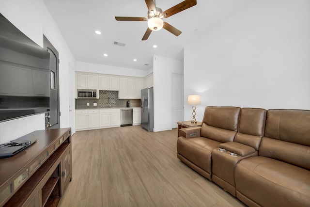 1827 Woodtrace Blvd, Pinehurst, TX 77362 - living room featuring a ceiling fan, light wood finished floors, and recessed lighting